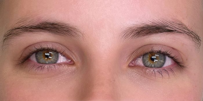 Before: natural brows and straight lashes.