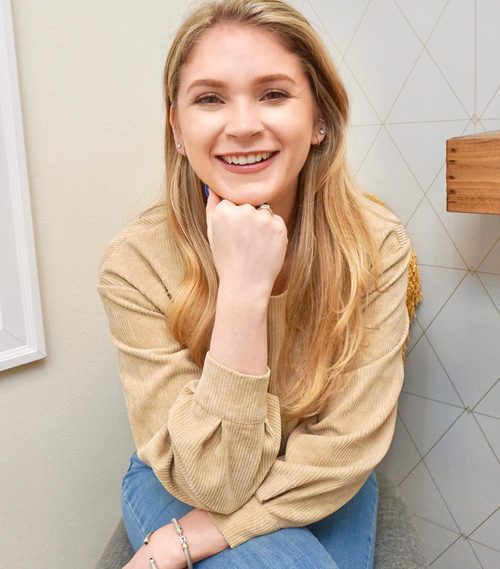 Lindsay, owner of Beauty by LC, smiling with her chin resting on her hand